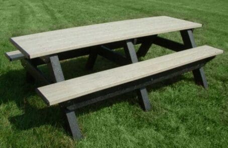 Deluxe 8 ft outdoor park picnic table made of recycled plastic. Shown with a black frame and weathered top and seat boards.