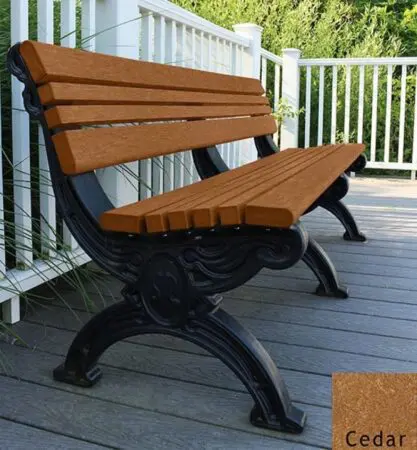 The Cambridge 6 ft. recycled plastic bench is very stylish with the ornately molded black frames that look like cast metal but are made of recycled plastic. The cedar color seat and back are made of 2"x 2" slats set between 2" x 4" bullnose edge boards. It's placed on a deck next to the railing.