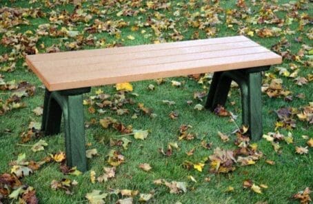 The Deluxe 4 ft flat bench is made of recycled plastic. Shown with a green frame and cedar boards.
