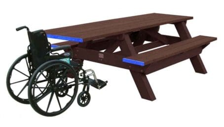 A Deluxe ADA outdoor picnic table with wheelchair access on one end. Made of recycled HDPE plastic. Shown with a brown frame and brown top and seat boards.