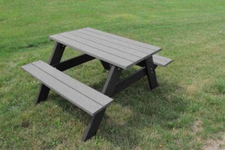 An Economizer 4 foot small outdoor picnic table made of recycled plastic. Shown with a black frame and charcoal top and seat boards.