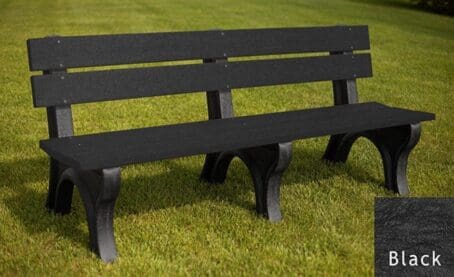 The Economizer Traditional 6 foot outdoor park bench made of 100% recycled HDPE plastic. This bench has the same design as our Traditional 6' bench, but made with smaller, lighter 1 1/4"x5" planks. Shown on grass with a black frame and black boards.