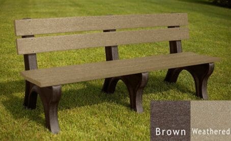 The Economizer Traditional 6' commercial outdoor park bench made of 100% recycled HDPE plastic. This bench has the same design as our Traditional 6' bench, but made with smaller, lighter 1 1/4"x5" planks. Shown on grass with a brown frame and weathered boards.