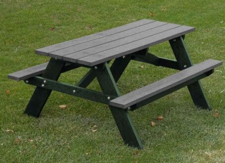 Economizer Youth Picnic Table made out of 100% recycled plastic. This table is designed for ages 3-9. Shown with a green frame and charcoal table and seat boards.