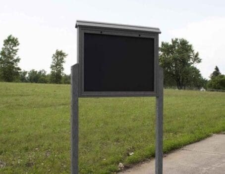 Charcoal Large Message Center 2 Sideed with 2 posts anchored to park sidewalk