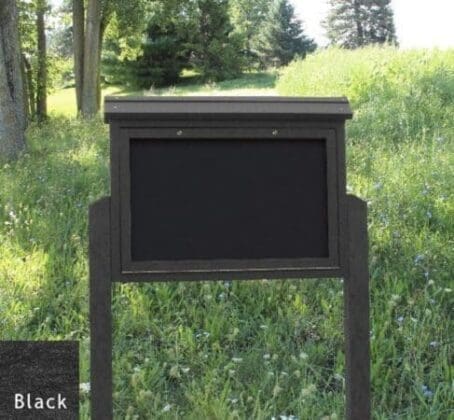 2 8ft posts Black Medium Message Center in open field display setting