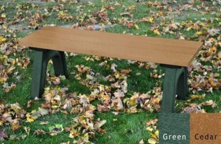 Traditional 4 foot outdoor flat bench made with 100% recycled plastic. This bench is made with our strong and sturdy 2"x6" planks making it perfect for sports areas, parks and trails. Shown on grass with a green frame and cedar boards.