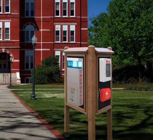 SOS Emergency AED Kiosk with defibrillator and first aid kit installed on a university campus