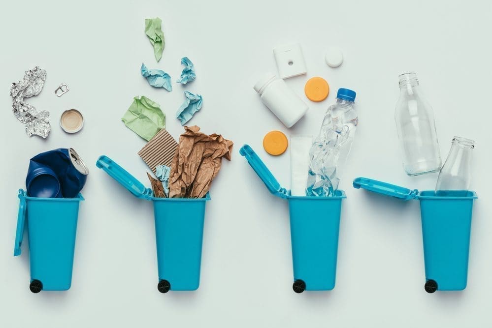 Recycling photo with multiple bins demonstrating how to recycle