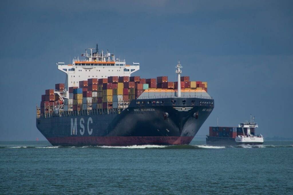 cargo ship heading into port loaded with containers