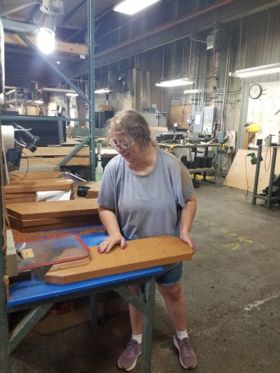 Shawn eases seat boards on a table router